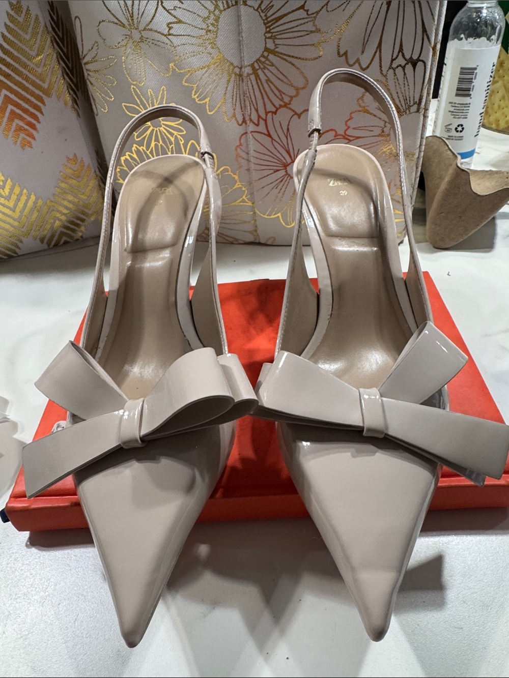 Patent Pointed-Toe Slingback Heels with Bow in Nude